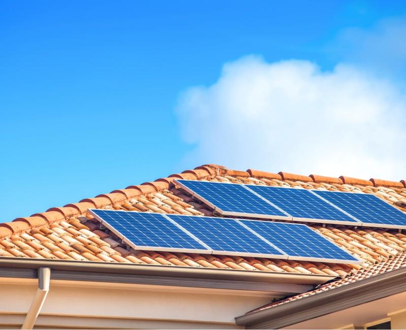 A photo of solar panels on a roof.
